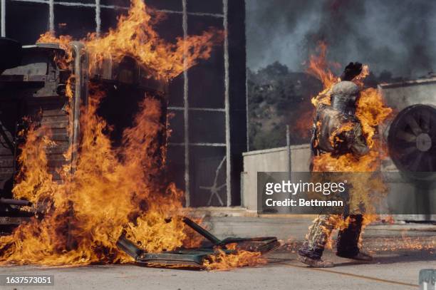 American stuntwoman Kitty O'Neil emerges from a burning van during a stunt she performs on NBC television special 'Superstunt', Hollywood,...