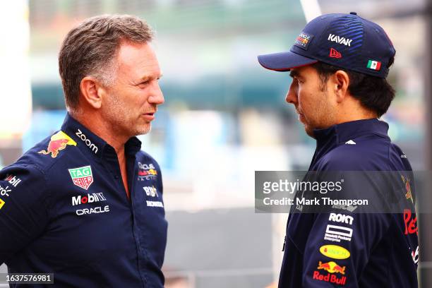 Red Bull Racing Team Principal Christian Horner and Sergio Perez of Mexico and Oracle Red Bull Racing talk in the Paddock prior to practice ahead of...