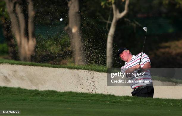 Richard Finch of England plays out of a bunker during day two of the Avantha Masters at Jaypee Greens Golf Club on March 15, 2013 in Delhi, India.