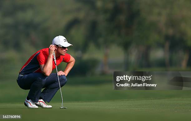 Magnus A Carlsson of Sweden lines up a putt during day two of the Avantha Masters at Jaypee Greens Golf Club on March 15, 2013 in Delhi, India.