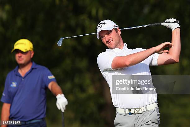 Marc Warren of Scotland lets go of the club after he took a shot during day two of the Avantha Masters at Jaypee Greens Golf Club on March 15, 2013...