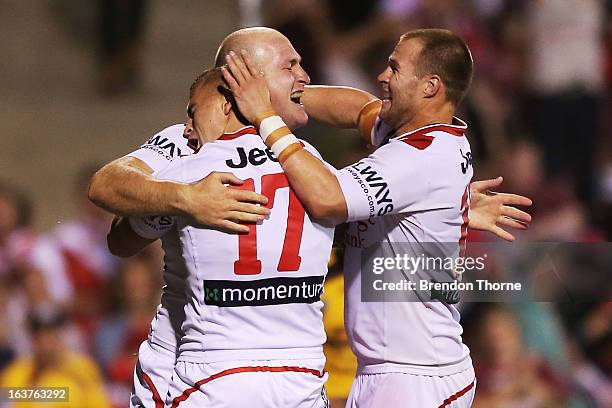 Michael Weyman of the Dragons celebrates with team mates after scoring the opening try during the round two NRL match between the St George Dragons...