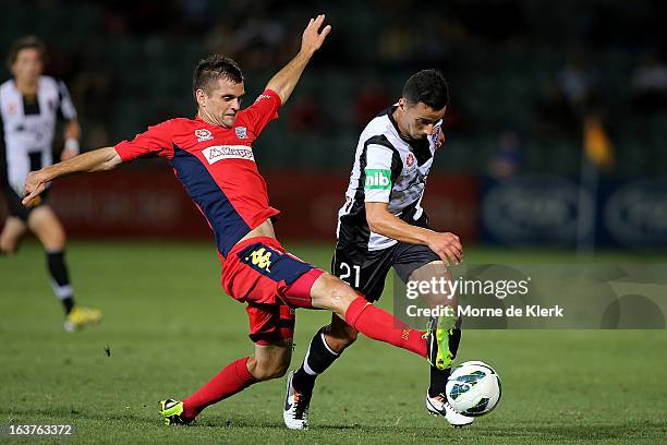 Cameron Watson of Adelaide tackles Marko Jesic of the Jets during the round 25 A-League match between Adelaide United and the Newcastle Jets at...