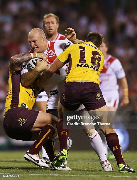 Michael Weyman of the Dragons is tackled by the Broncos defence during the round two NRL match between the St George Dragons and the Brisbane Broncos...