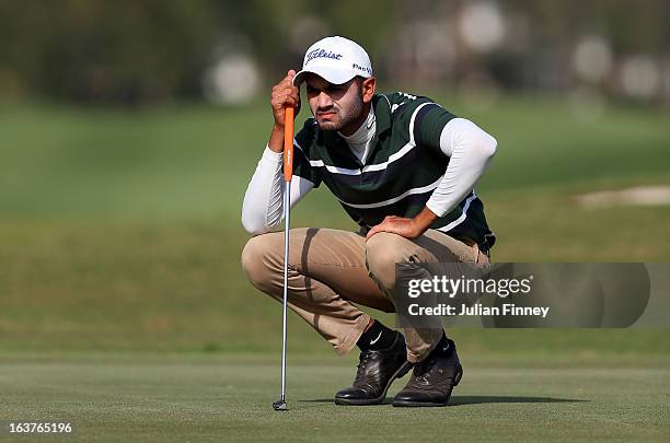 Abhijit Singh Chadha of India lines up a putt during day two of the Avantha Masters at Jaypee Greens Golf Club on March 15, 2013 in Delhi, India.