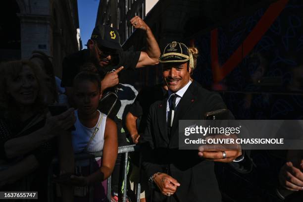 New Zealand's scrum-half Aaron Smith takes selfies with fans during a welcoming ceremony at the town hall with mayor Gregory Doucet in Lyon,...