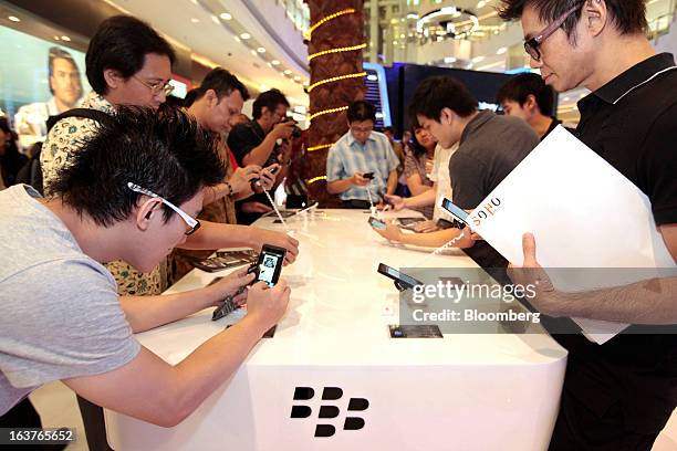 Customers view the BlackBerry Z10 smartphone during the consumer launch of the device at the Central Park Mall in Jakarta, Indonesia, on Friday,...