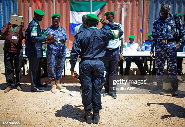 Picture taken on March 15, 2013 and released by the African Union-United Nations Information Support Team, shows an officer from the Sierra Leonean...