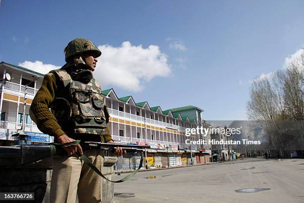 Paramilitary soldier stands guard during a curfew, on March 15, 2013 on Srinagar, India. Curfew continued for the second consecutive day in Srinagar...