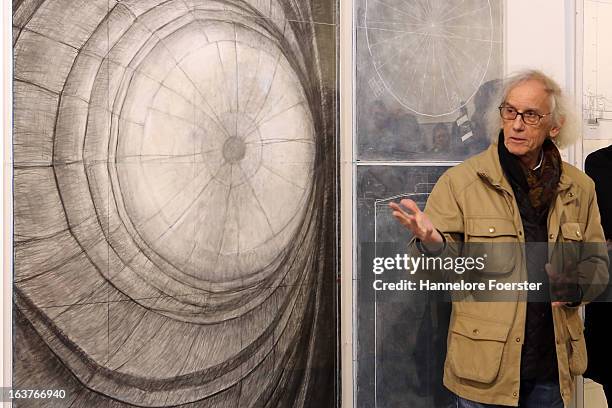 Bulgarian-born artist Christo poses in front of his paintings at an exhibition of his large-scale environmental art Big Air Package in a former gas...