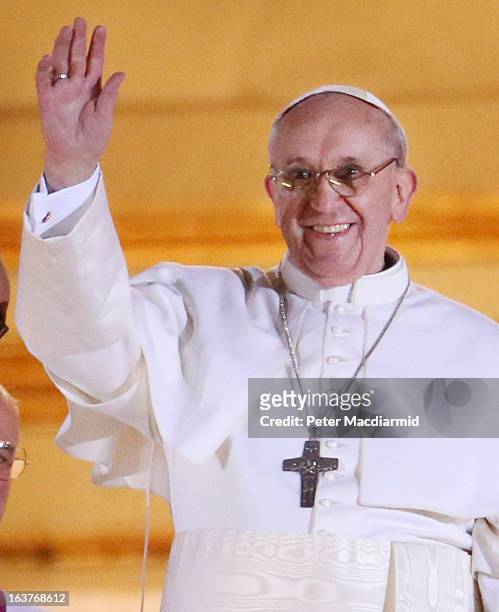 Newly elected Pope Francis waves to the waiting crowd from the central balcony of St Peter's Basilica on March 13, 2013 in Vatican City, Vatican....