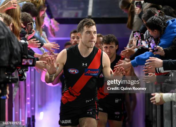 Zach Merrett of the Bombers leads his team out onto the field during the round 24 AFL match between Essendon Bombers and Collingwood Magpies at...