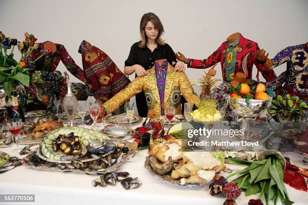 Final touches are put to "The Last Supper " part of the Pop! exhbition by Yinka Shonibare, MBE, at the The Stephen Friedman Gallery on March 15, 2013...