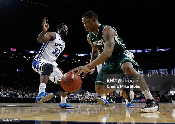 Darion Clark of the Charlotte 49ers drives to the net against Cory Remekun of the Saint Louis Billikens during the Quarterfinals of the Atlantic 10...