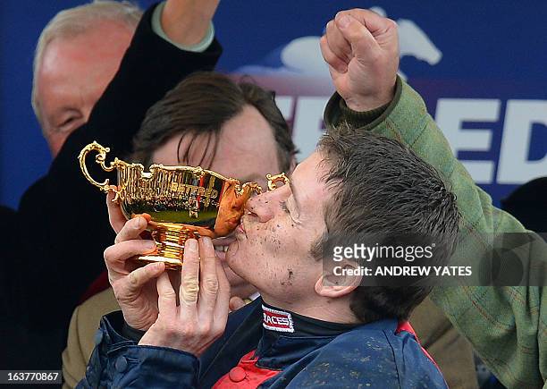 Barry Geraghty kisses the cup after winning the Betfred Cheltenham Gold Cup Steeple Chase riding horse 'Bobs Worth' during the last day of the...
