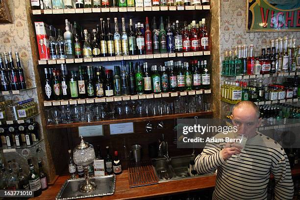 Martial Philippi, owner of the Absinth Depot shop, drinks a glass of absinthe on March 15, 2013 in Berlin, Germany. The highly alcoholic drink...