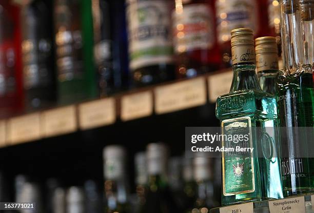 Bottles of absinthe sit on a shelf for sale at the Absinth Depot shop on March 15, 2013 in Berlin, Germany. The highly alcoholic drink absinthe was...