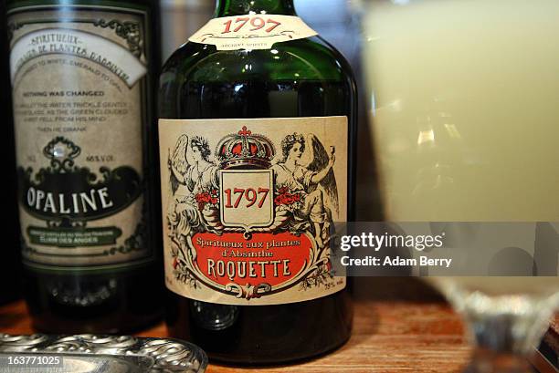Bottles of absinthe sit next to a prepared glass of the drink at the Absinth Depot shop on March 15, 2013 in Berlin, Germany. The highly alcoholic...