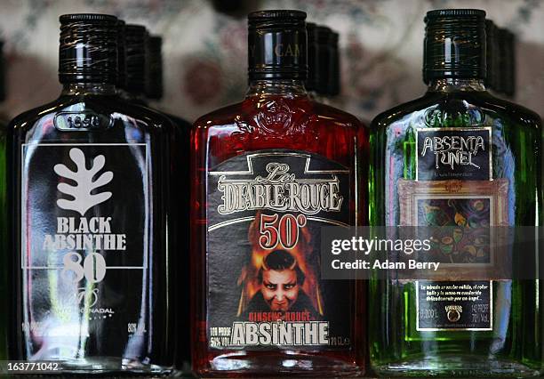 Bottles of absinthe sit on a shelf for sale at the Absinth Depot shop on March 15, 2013 in Berlin, Germany. The highly alcoholic drink absinthe was...