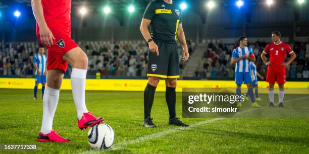 football player with foot on ball - referee shirt stock pictures, royalty-free photos & images