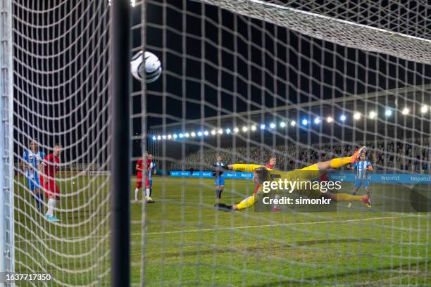 football player diving mid-air - footballer stock pictures, royalty-free photos & images