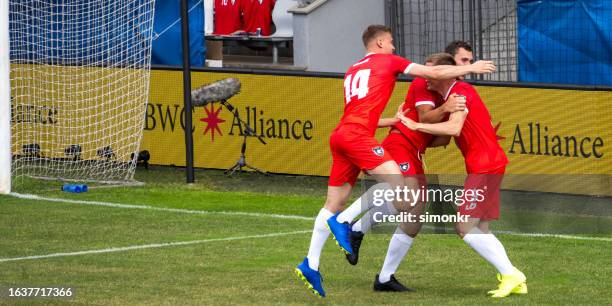 football player celebrating on football field - professional soccer team stock pictures, royalty-free photos & images