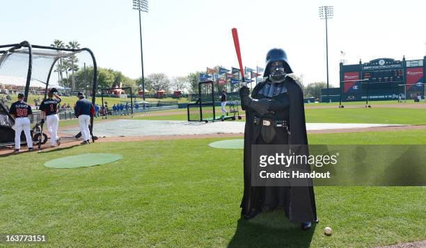 In this handout image provided by Disney Parks, Darth Vader poses with a red lightsaber bat before a Braves spring training game at Champion Stadium...