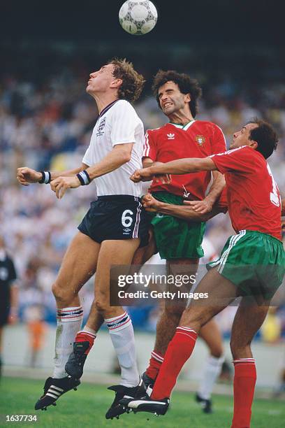 Terry Butcher of England jumps with Pereira and Pachaco of Portugal during the World Cup match in Monterrey, Mexico. Portugal won the match 1-0. \...