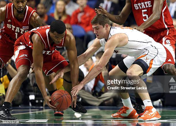 Richard Howell of the North Carolina State Wolfpack battles for a loose ball with Joe Harris of the Virginia Cavaliers during the quarterfinals of...