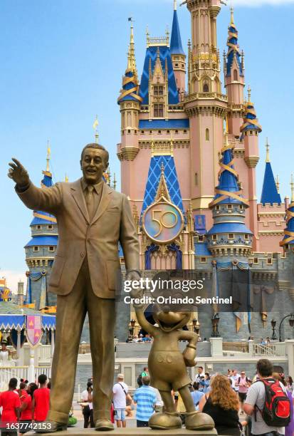 "The Partners" statue in front of Cinderella Castle and the new 50th Anniversary crest in the Magic Kingdom at Walt Disney World, in Lake Buena...