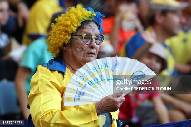 Sochaux-Montbeliard's supporter uses a fan during the French National league football match between FC Sochaux-Montbeliard and GOAL FC at The Auguste...