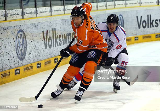 Levi Nelson of Wolfsburg and Daniel Weiss of Nuernberg battle for the puck in game two of the DEL pre-play-offs between Grizzly Adams Wolfsburg and...