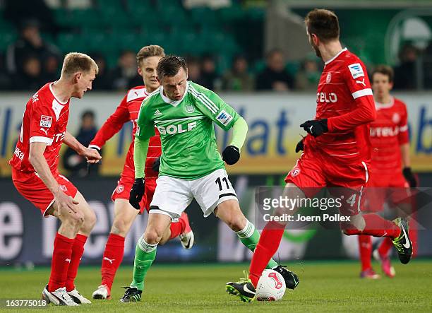 Ivica Olic of Wolfsburg and Axel Bellinghausen and Johannes van den Bergh of Duesseldorf compete for the ball during the Bundesliga match between VfL...
