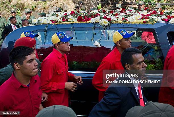 The hearse with the remains of late Venezuelan President Hugo Chavez is taken from the Military Academy to his resting place at the former "4 de...