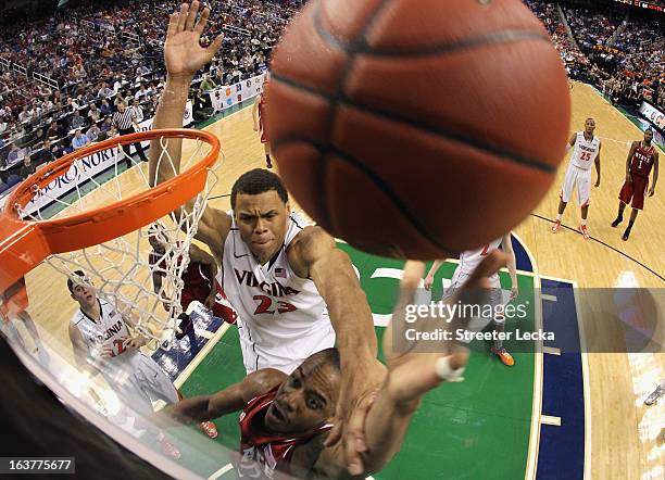 Justin Anderson of the Virginia Cavaliers tries to block Lorenzo Brown of the North Carolina State Wolfpack during the quarterfinals of the Men's ACC...