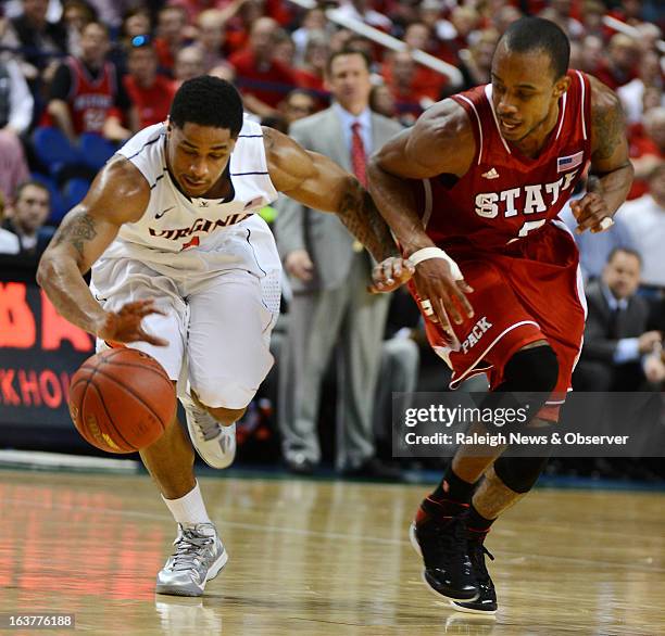 Virginia guard Jontel Evans and North Carolina State guard Lorenzo Brown race for a loose ball in the second half of a quarterfinal of the ACC Men's...