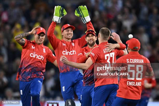 England players celebrate with England's Gus Atkinson after he takes the wicket of New Zealand's Devon Conway during the second T20 international...