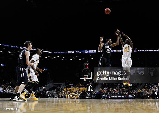 Tyrone Garland of the La Salle Explorers shoots over Kameron Woods of the Butler Bulldogs during the Quarterfinals of the Atlantic 10 Basketball...