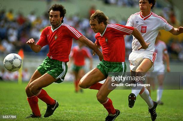 Frederico and Sousa of Portugal get away from Urban of Portugal during a World Cup match at the Universitario in Monterrey, Mexico. Portuugal won the...
