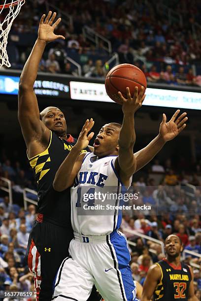 Rasheed Sulaimon of the Duke Blue Devils goes up against Charles Mitchell of the Maryland Terrapins in the first half of their game during the...
