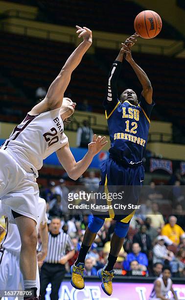Louisiana State University-Shreveport's Tevin Hall and Evangel University's Stephen Cotten reach for a rebound in the NAIA tournament on Friday,...