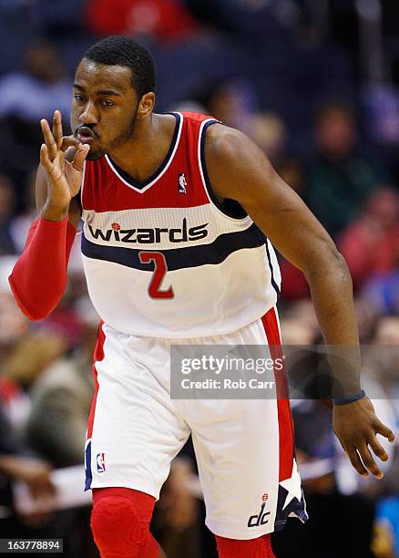 John Wall of the Washington Wizards celebrates after hitting a three pointer against the New Orleans Hornets during the first half at Verizon Center...