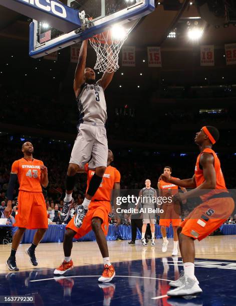 Mikael Hopkins of the Georgetown Hoyas dunks in the second half against the Syracuse Orange during the semifinals of the Big East Men's Basketball...