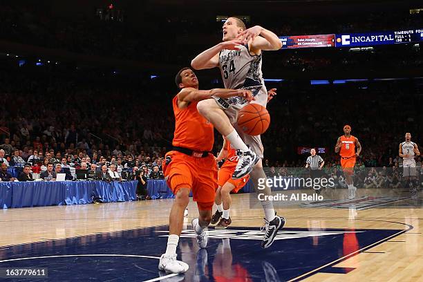 Nate Lubick of the Georgetown Hoyas has the ball knocked loses as he drove to the basket in the second half against Michael Carter-Williams of the...
