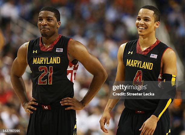 Pe'Shon Howard and Seth Allen of the Maryland Terrapins celebrate during their 83 to 74 win over the Duke Blue Devils during the quarterfinals of the...