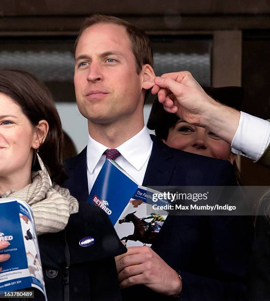 Prince William, Duke of Cambridge has his ear pulled by a friend as he and Catherine, Duchess of Cambridge watch the racing on Day 4 of The...