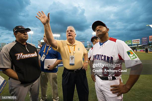 Manager Tony Pena of Team Dominican Republic and manager Luis Sojo of Team Venezuela are given the ground rules by MLB representative Larry Young...