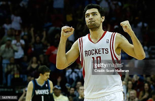 Carlos Delfino of the Houston Rockets celebrates a basket during the game against the Minnesota Timberwolves at Toyota Center on March 15, 2013 in...