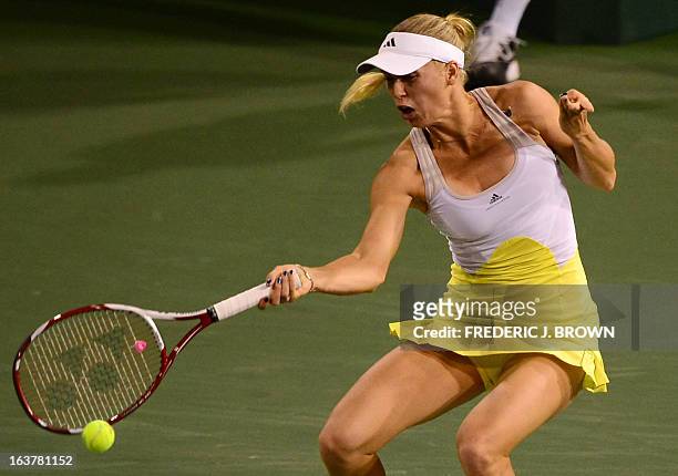 Caroline Wozniacki of Denmark hits a return to Angelique Kerber of Germany on March 15, 2013 in Indian Wells, California, during their semifinal...
