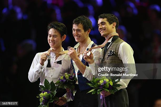 Patrick Chan of Canada celebrates winning the gold medal with Denis Ten of Kazakhstan winning silver medal and Javier Fernandez of Spain winning the...